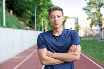 Portrait of happy sportsman at stadium. Healthy lifestyle