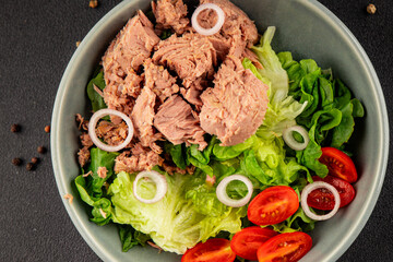 Tuna salad green leaf lettuce, canned tuna, tomato fresh delicious gourmet food background on the table rustic food top view copy space keto and paleo diet vegetarian food pescetarian diet