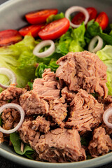 Tuna salad green leaf lettuce, canned tuna, tomato fresh delicious gourmet food background on the table rustic food top view copy space keto and paleo diet vegetarian food pescetarian diet