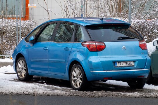 Blue Citroen C4 Picasso MPV car parked on street, rear side view in winter
