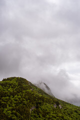 Looking towards Mount Lafayette from Artist's Bluff in the White Mountains of New Hampshire. The clouds are blowing over the tops of the mountains after a June rainstorm. Some of the peaks are hidden.