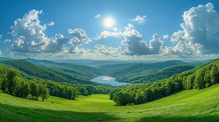 Obraz premium Panoramic vista of lush green valley, a serene lake nestled in the mountains, a vibrant blue sky dotted with fluffy white clouds, and a bright sun