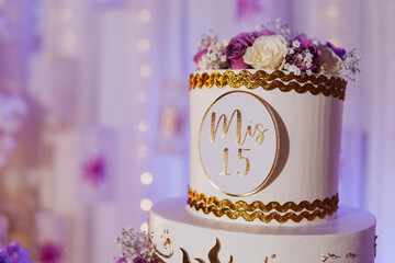quinceanera cake on a table with decorations
