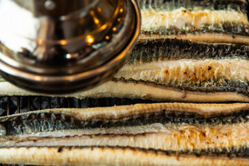 roasting eels on the charcoal grill