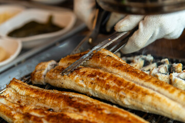 roasting eels on the charcoal grill