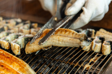 roasting eels on the charcoal grill