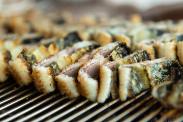 roasting eels on the charcoal grill