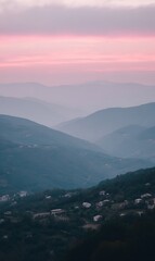 Hazy mountain landscape village at dusk