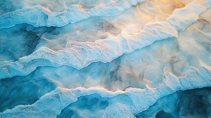 Obraz premium Majestic aerial view of snowy mountain peaks under clear blue skies in winter