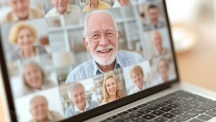 laptop screen showing virtual book club meeting with smiling faces, symbol of modern connectivity in retirement