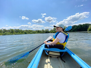 Female Kayaker Enjoying Nature. Scenic Water Journey.