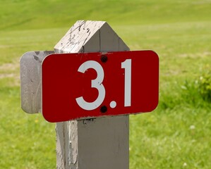 A close view on the red mile marker sign.