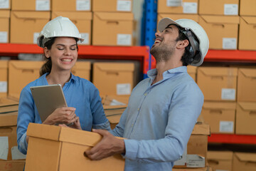 Warehouse worker working in warehouse storage. Foreman or worker work at factory site check up...