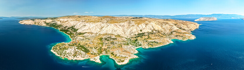 Wide drone panorama of island Krk, Croatia.  Coastline surrounded by deep blue water. The island...