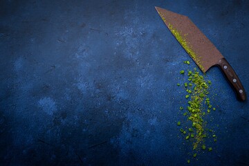 Knife with herbs on blue background