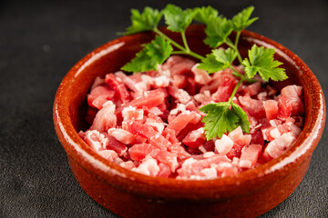 Bacon cubes smoked chopped meat small pieces fresh delicious gourmet food background on table rustic food top view copy space