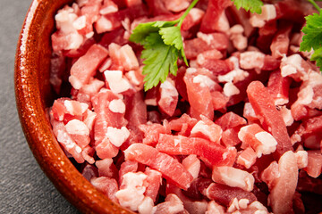 Bacon cubes smoked chopped meat small pieces fresh delicious gourmet food background on table rustic food top view copy space