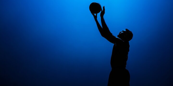 A basketball player in mid-dunking motion against a vibrant blue background, emphasizing intense athletic prowess and dynamic skill featuring action elements creating an impressive visual impact. - Powered by Adobe