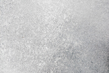 Concrete surface with texture highlighting patterns and shades of gray