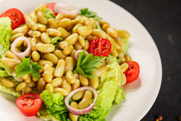 Bean salad green leaf lettuce, tomato, onion vegetables dish fresh delicious gourmet food background on the table rustic food top view copy space keto and paleo diet vegan and vegetarian food