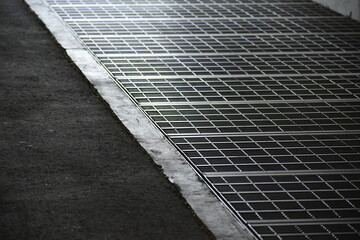 Sidewalk drain with cover.