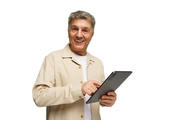 Engaging senior man smiles while using a tablet, showcasing enthusiasm and connection in a bright,...