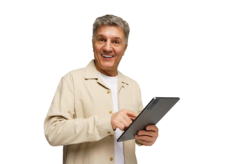 Engaging senior man smiles while using a tablet, showcasing enthusiasm and connection in a bright, without a background