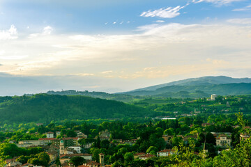 travel summer view from hill to a nice european town with amazing buildings, green hills and...