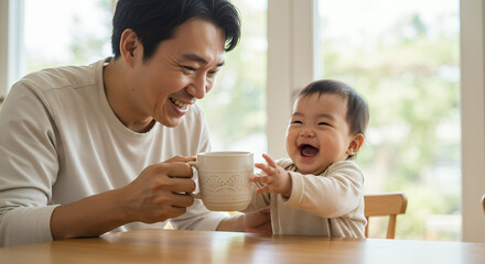 Smiling father and son in the kitchen, they are having breakfast