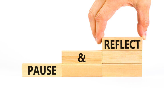 Pause and reflect symbol. Concept words Pause and reflect on beautiful block. Businessman's hand. Beautiful white background. Business motivational lifestyle pause and reflect concept. Copy space.