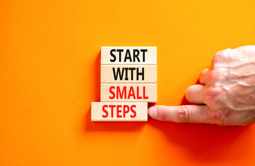 Start with small steps symbol. Concept words phrase Start with small steps on beautiful wooden...