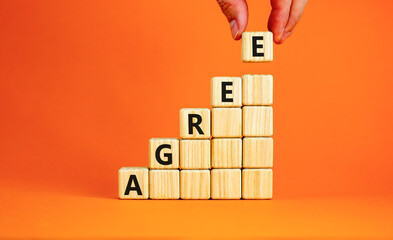 Agree symbol. Concept word Agree on beautiful wooden blocks. Beautiful orange table orange...