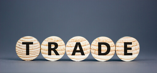 Trade symbol. Concept word Trade on beautiful wooden circles. Beautiful grey table grey background....