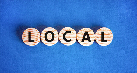 Local symbol. Concept word Local on beautiful wooden circles. Beautiful blue table blue background....