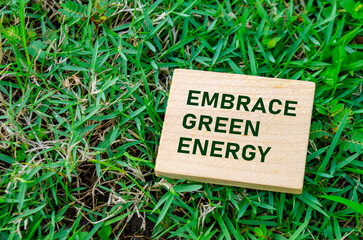 Embrace Green Energy text on wooden block, promoting the shift toward clean and renewable energy. Sustainable living concept