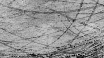 Aerial view car tire marks abstract street road background with black tire marks on race track,...