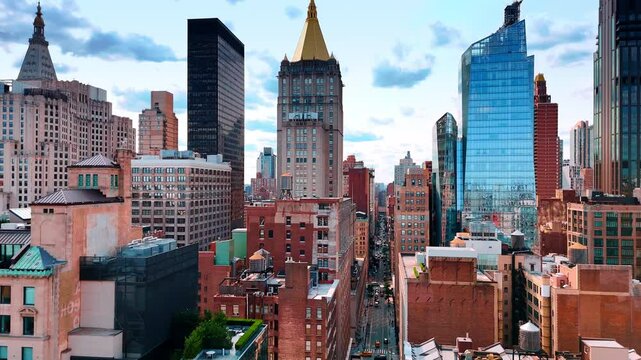 Going up over the busy long straight street crossing the scenery of New York, USA. View on the Life Insurance Building in the center of a picture.