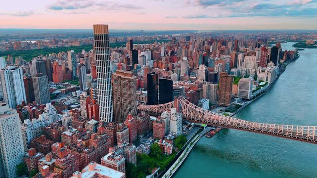 Urban landscape of New York at sunset time. Aerial view on the Queensboro Bridge and multiple high-rises of Manhattan.