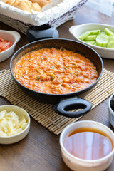 Turkish style breakfast: menemen eggs, chechil cheese, white cheese, kashar cheese and Turkish tea	