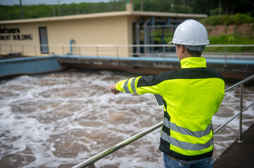 A wastewater treatment engineer is checking the operation of a water treatment system