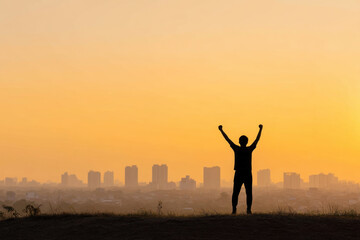 Silhouette person city skyline sunset victory success achievement outdoor happiness motivation inspiration urban landscape evening sky arms raised