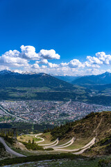 Beautiful aerial view of Innsbruck city and Tyrolean alps from Seegruben cable car station in spring on a sunny day, Innsbruck, Austria