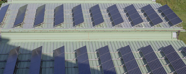 Solar panels installed on a green-roofed building in the Italian Alps. A modern approach to sustainability and clean energy in a scenic mountain environment.