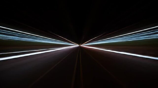 High-Speed Night Driving Light Trails - A long-exposure shot captures vibrant streaks of light from headlights and taillights on a highway at night, creating a dynamic and abstract composition.