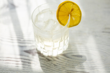 glass of cocktail with lemon close up