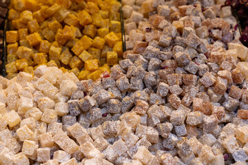 mini colors Turkish delights with roses on a white plate	
