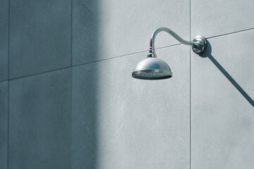 minimalist modern outdoor shower in spa zone positioned to right of frame