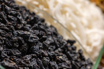 black dried grapes on the counter in the market