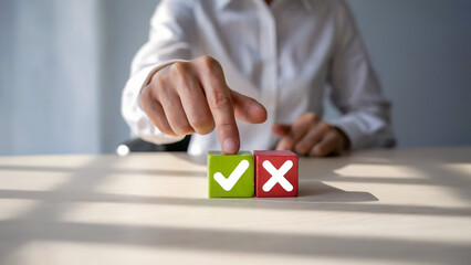 Close up of a person s finger pointing at a green block with a checkmark and a red block with an x