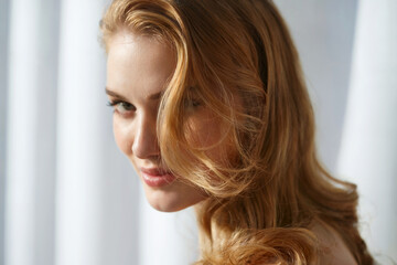 Naklejka premium Soft Gaze Wavy Hair Woman Closeup